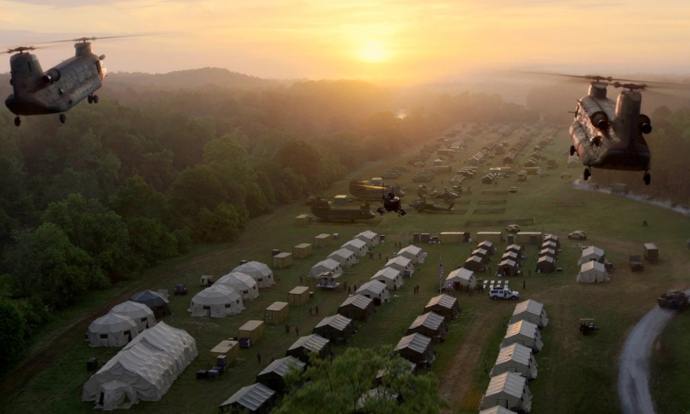 Helicopters fly over a military camp in Civil War.