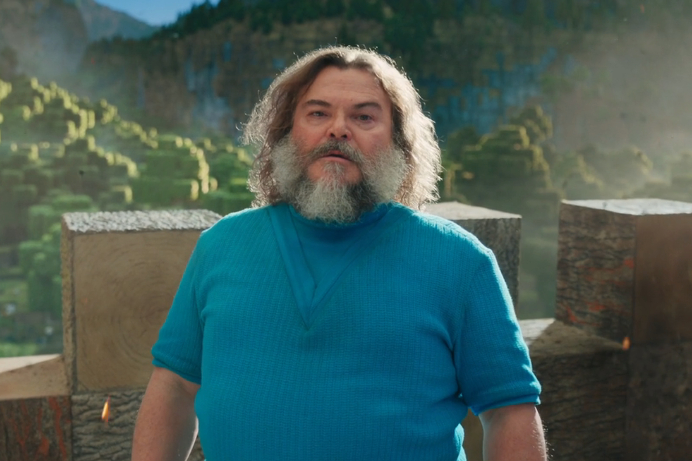 Jack Black stands near a castle wall in A Minecraft Movie.