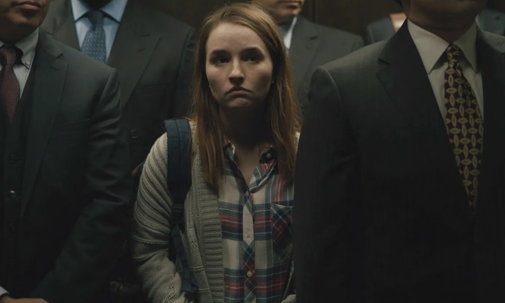 Kaitlyn Dever stands in a cramped elevator in Unbelievable.