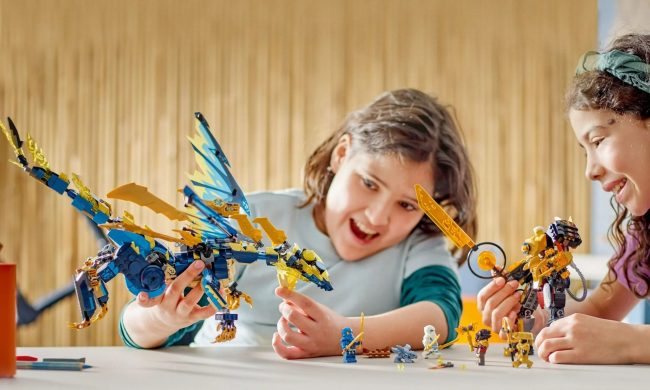 Two kids playing with the giant Lego Ninjago Elemental Dragon vs. The Empress Mech kit.