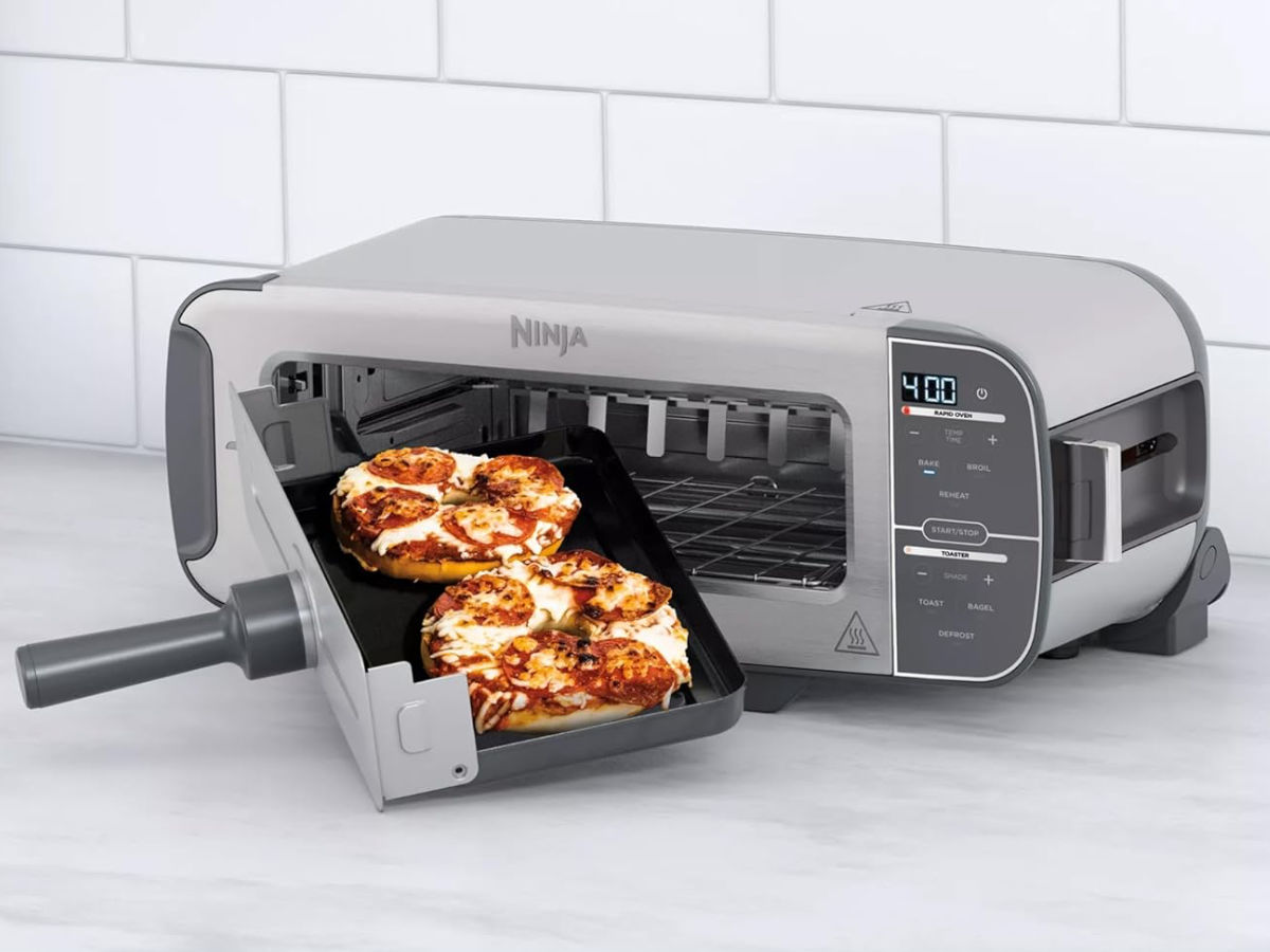 Pizza bagels being removed from the Ninja Foodi 2-in-1 Flip Toaster.