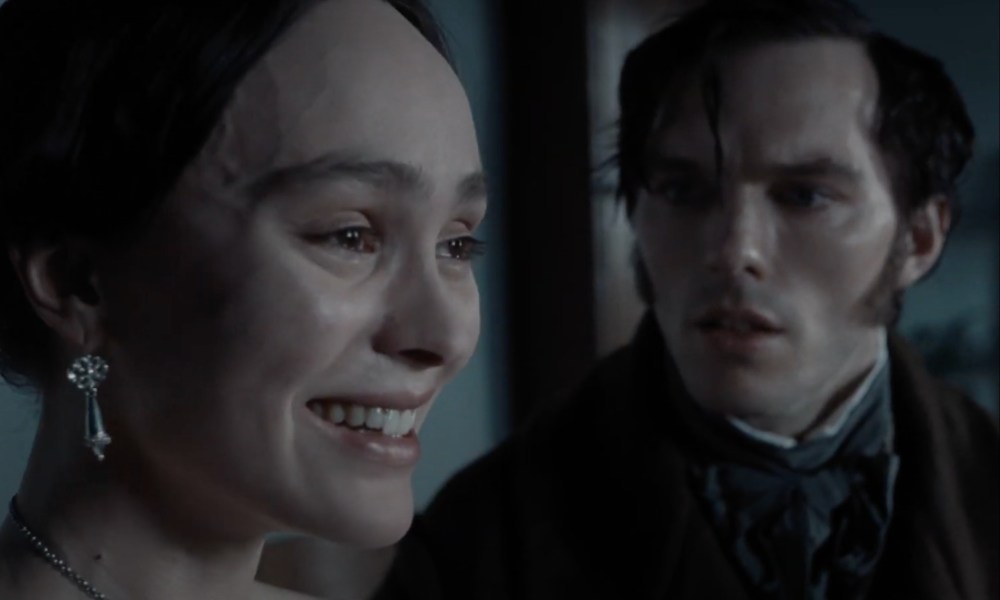 A woman smiles as a man looks worried to the side of her.