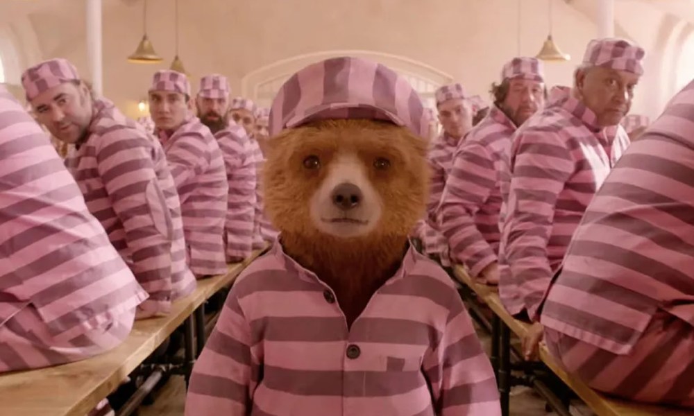 Paddington walks among the prisoners in Paddington 2.