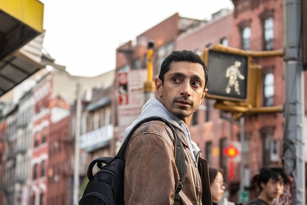 Riz Ahmed looks over his shoulder in a still from the movie Relay.