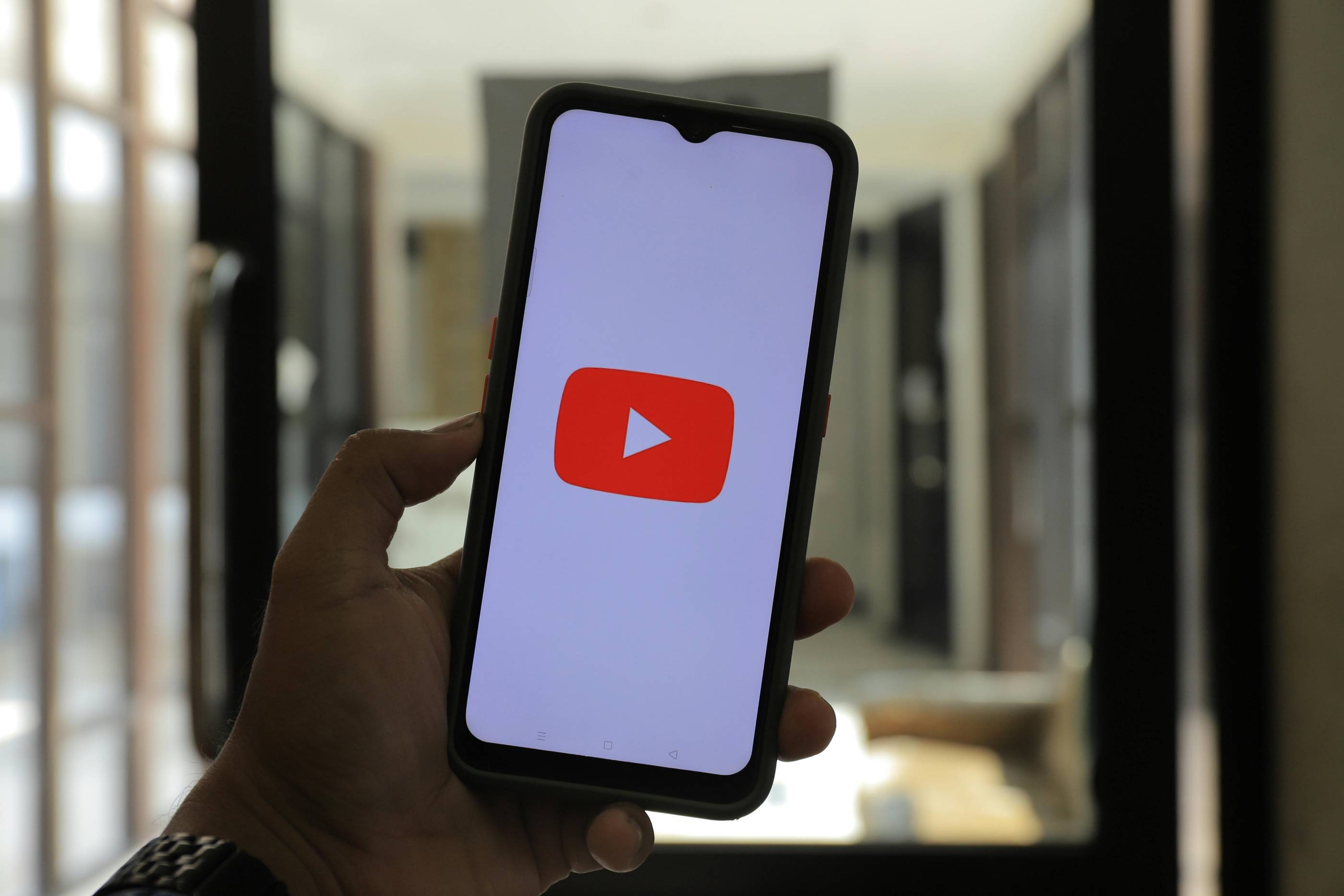 YouTube logo on a phone screen