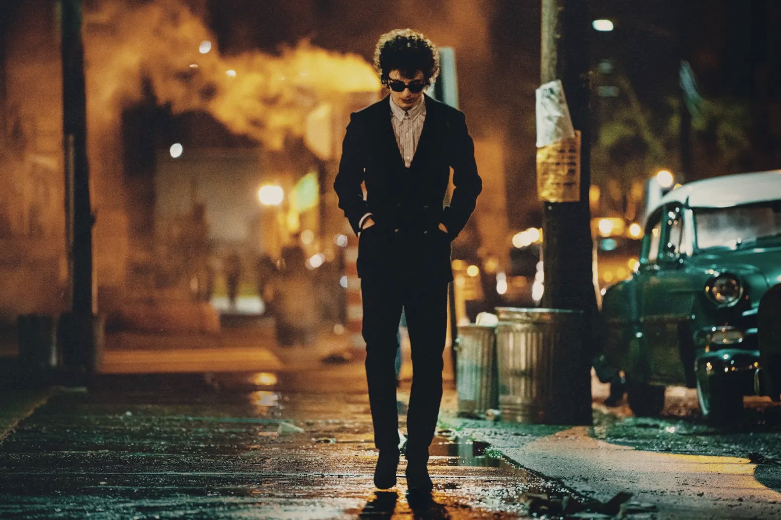 Bob Dylan walks down a street in A Complete Unknown.