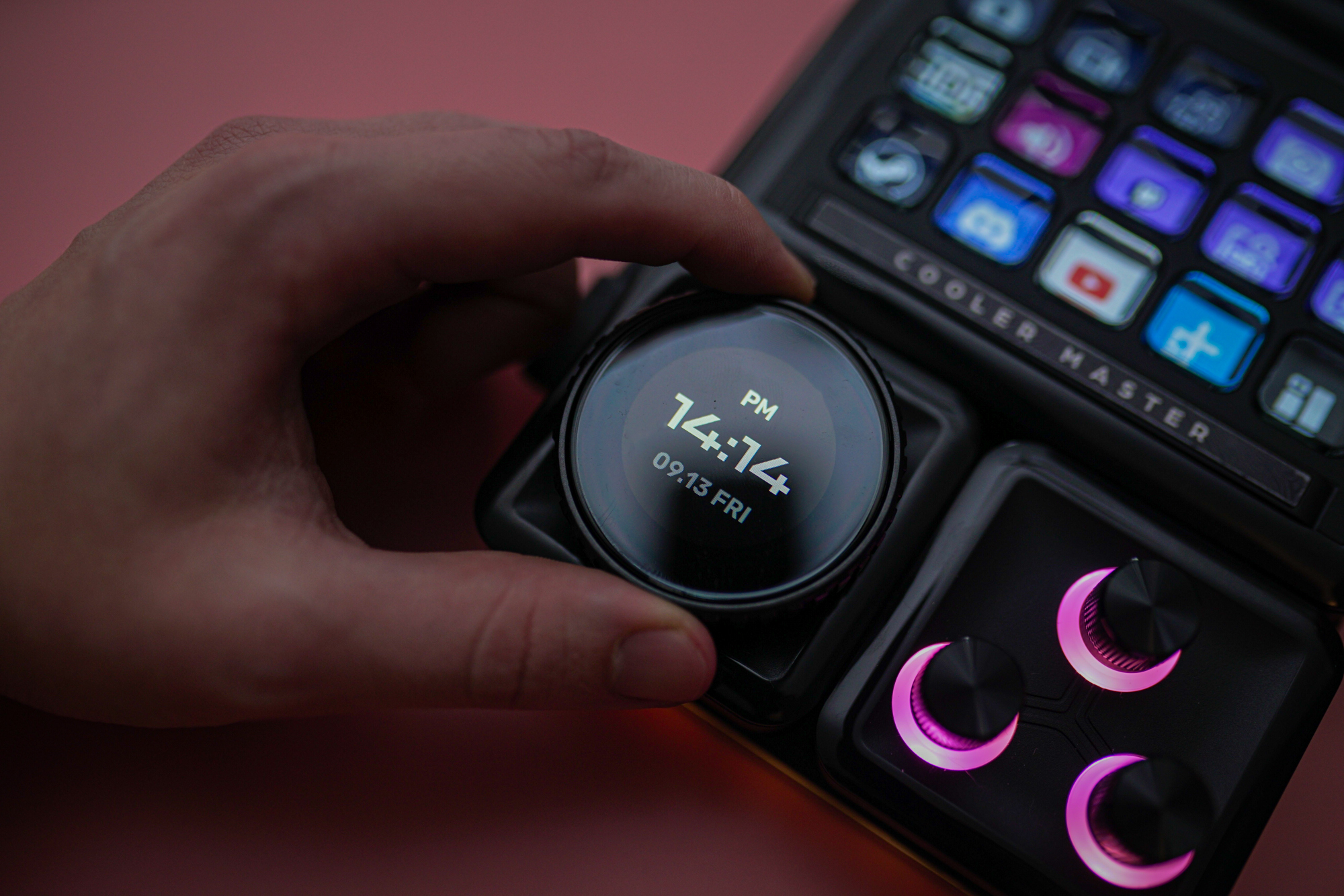 A hand spinning a wheel on the Cooler Master MasterHub.