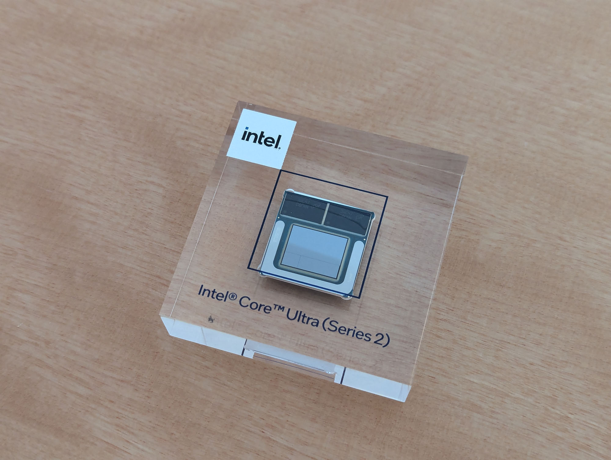 An Intel Core Ultra Series 2 chip embedded in a piece of glass.