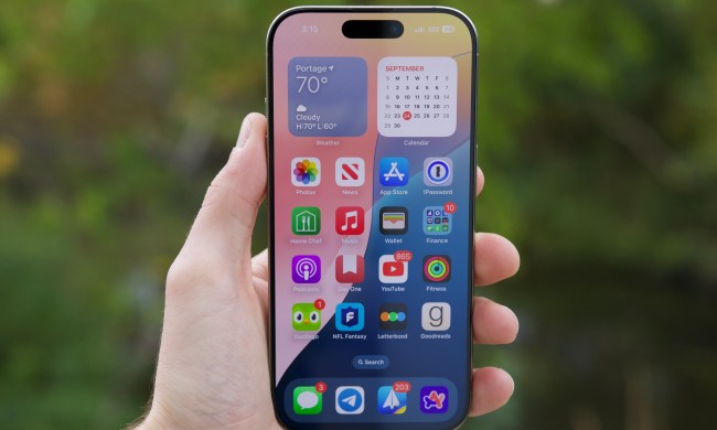 Someone holding the iPhone 16 Pro with its display on.