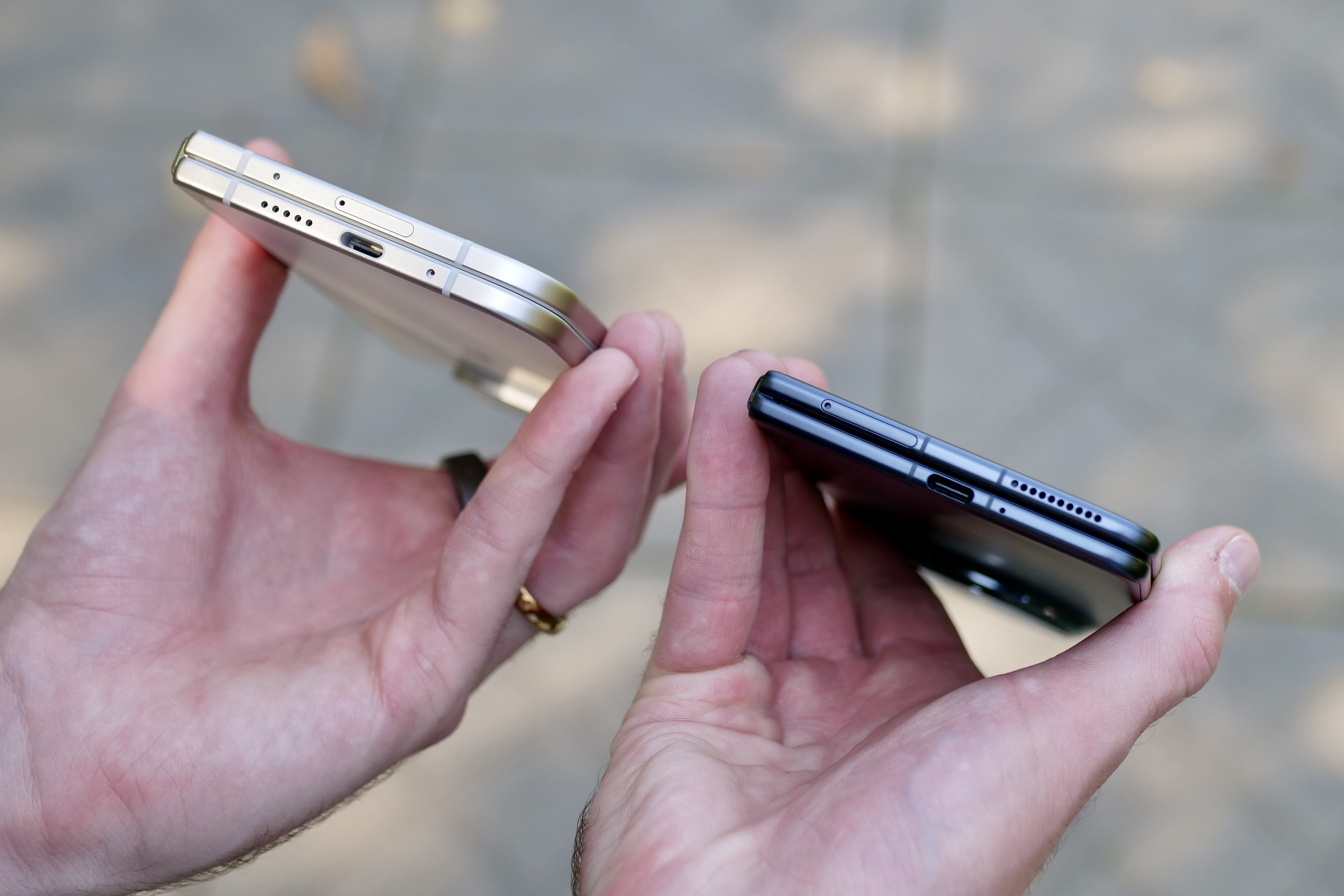 A person holding the Google Pixel 9 Pro Fold and Honor Magic V3.