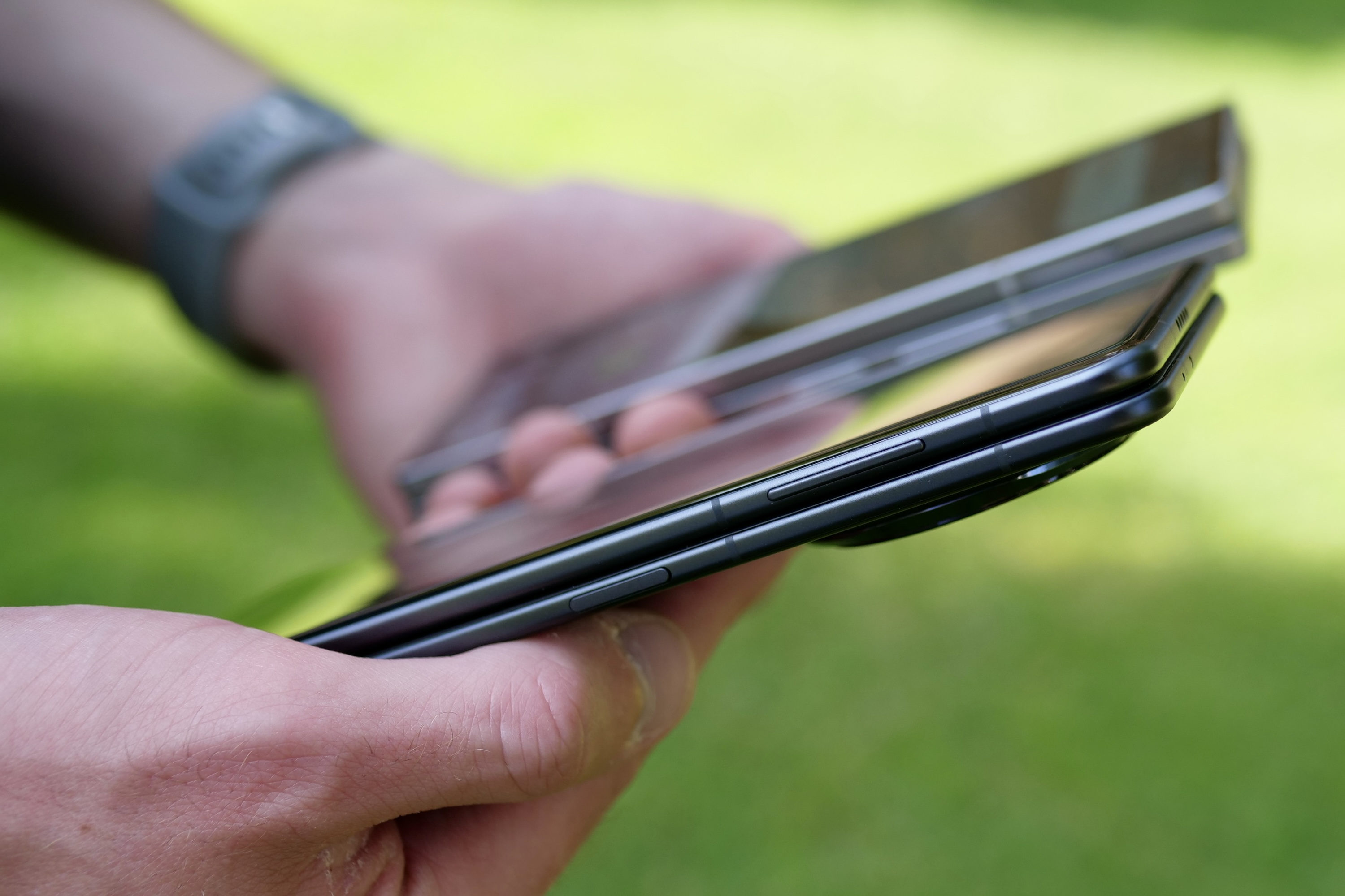 A person holding the Samsung Galaxy Z Fold 6 and Honor Magic V3.