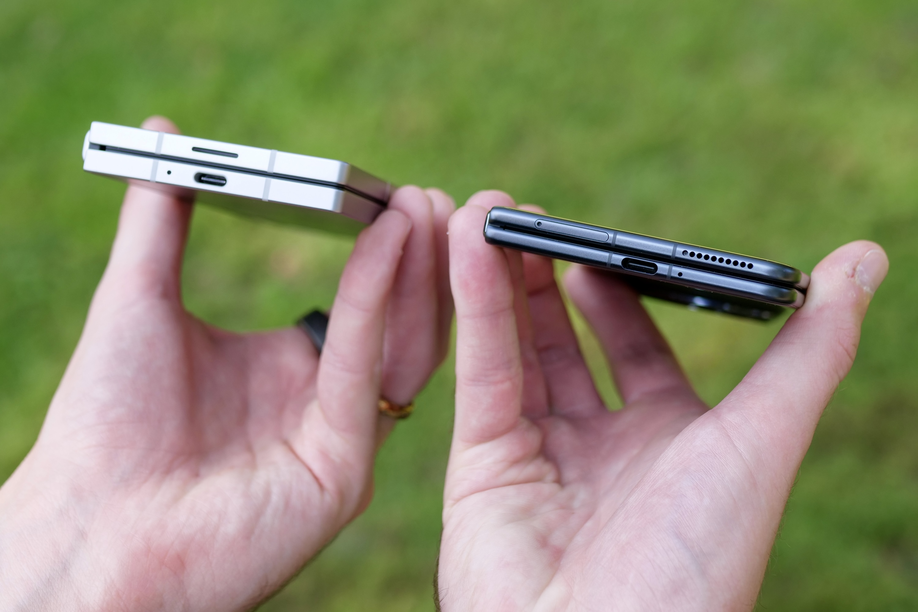 A person holding the Samsung Galaxy Z Fold 6 and Honor Magic V3.