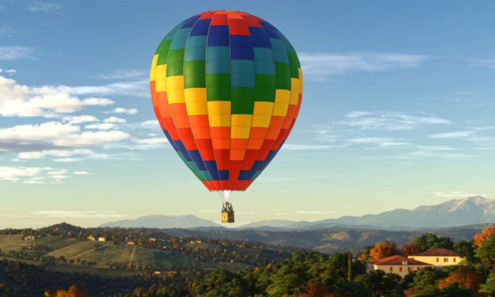 A rainbow colored hot air balloon in the sky.