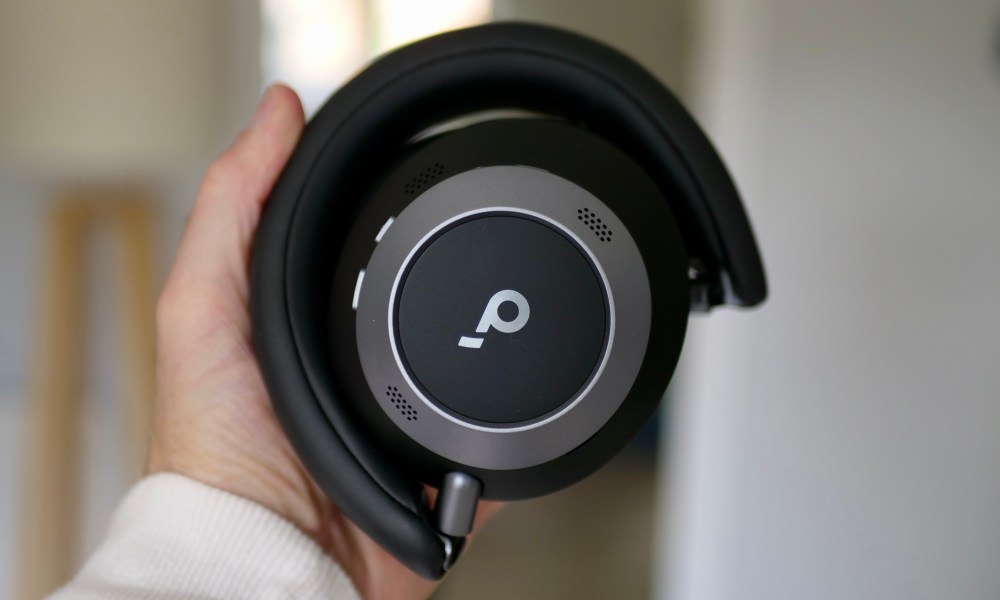 A person holding the folded Soundcore Space One Pro headphones.