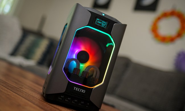 The Tecno Megamini G1 gaming PC sitting on a coffee table.