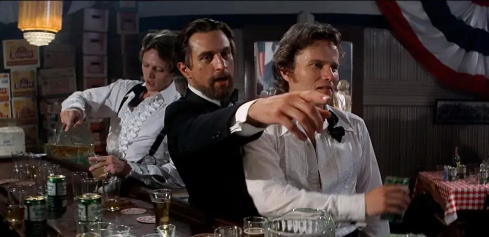 Three men sit at a bar in The Deer Hunter.