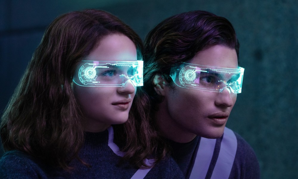 A man and a woman wear futuristic glasses in Uglies.