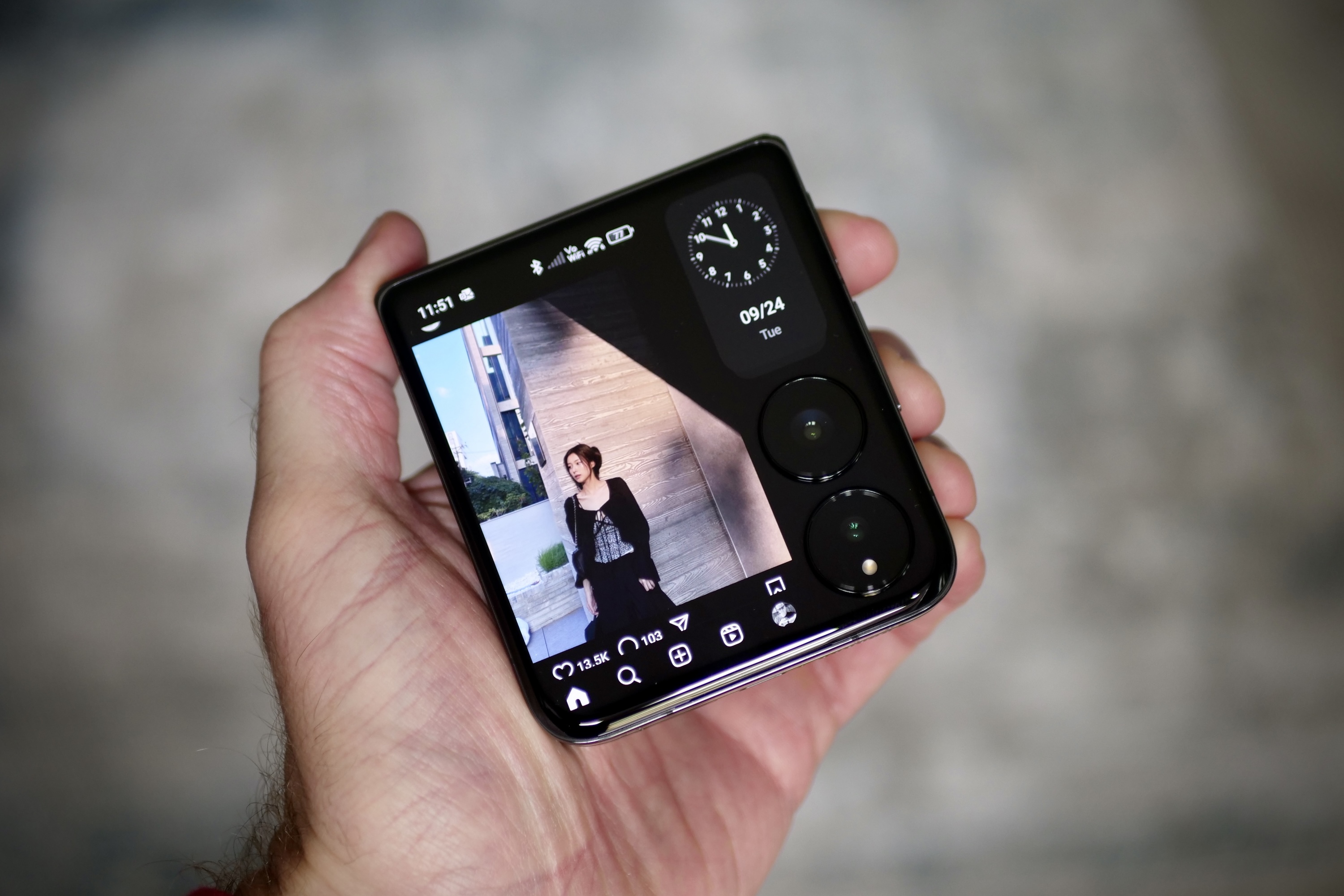 A person holding the Xiaomi Mix Flip, showing the Instagram app.