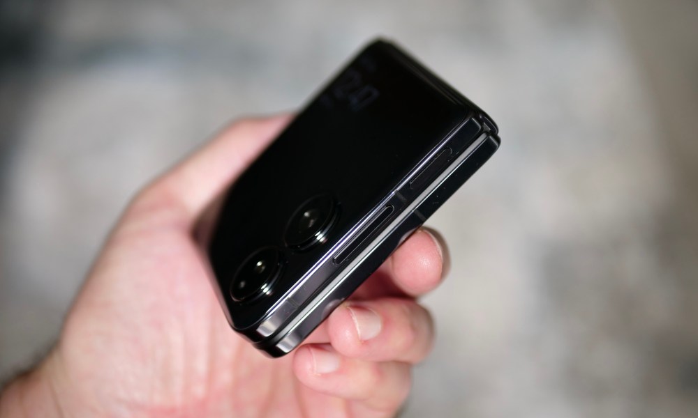 A person holding the Xiaomi Mix Flip, seen from the side.