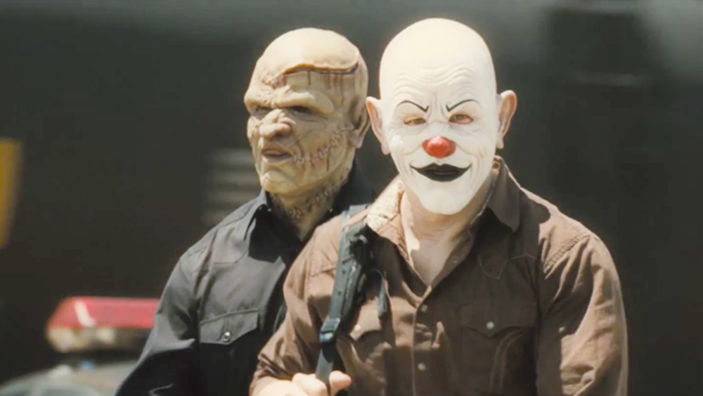 Two men in masks hold guns in 2 Guns.