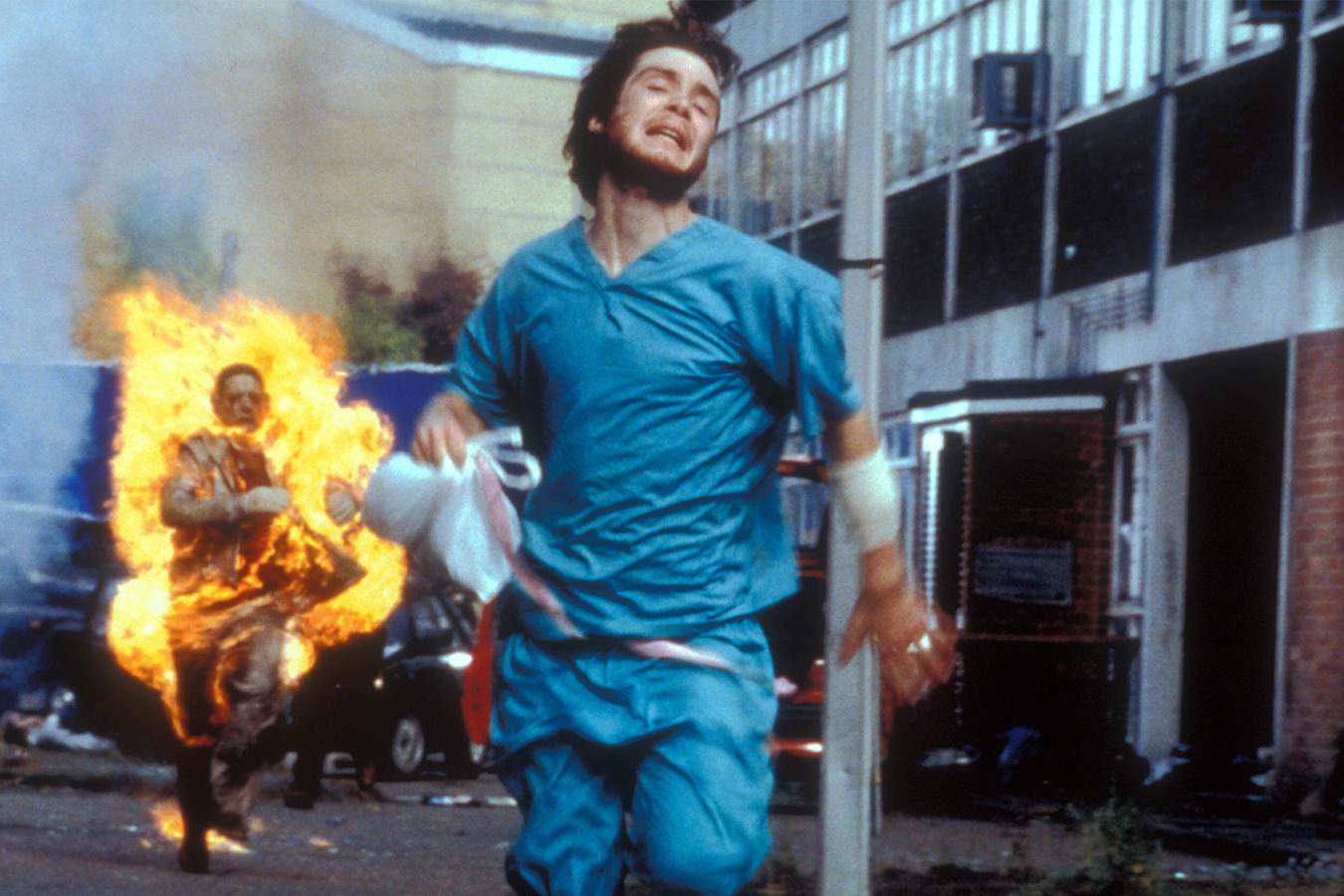 Cillian Murphy runs from a burning zombie in 28 Days Later.