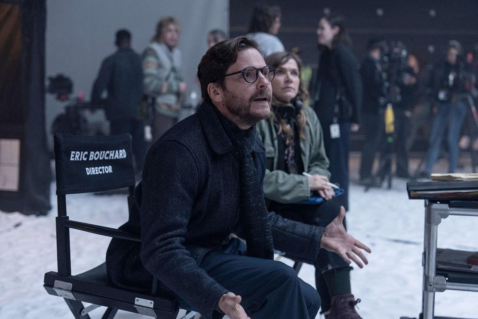 Daniel Bruhl sits in a director's chair in The Franchise.