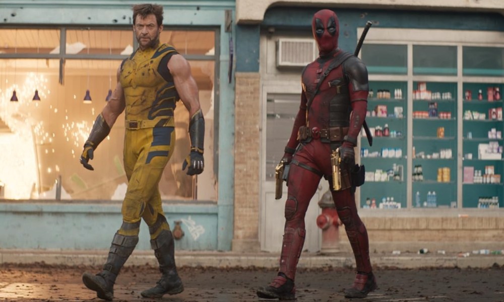 Wolverine and Deadpool walk down a street.