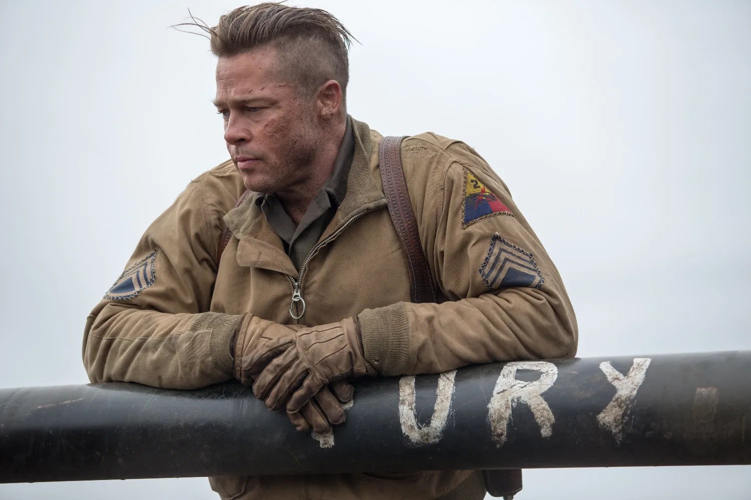 A man relaxes on a tank in Fury.