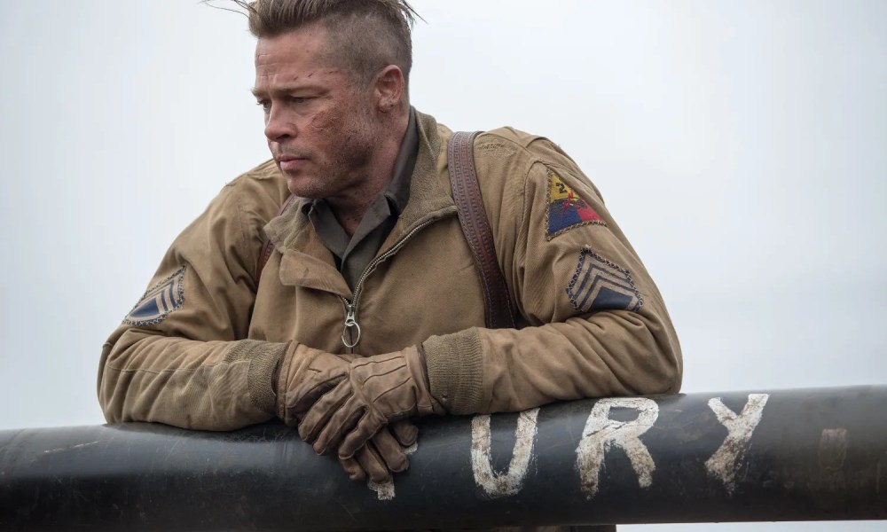 A man relaxes on a tank in Fury.