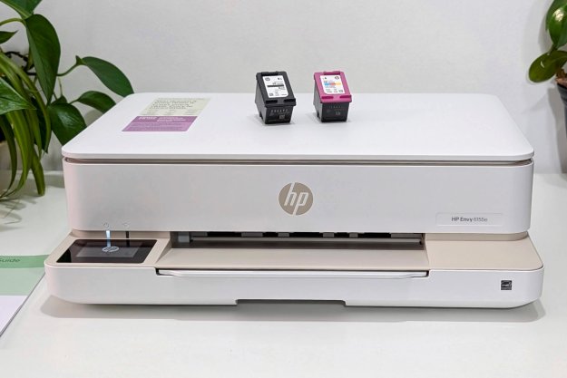 HP's low-profile Envy 6155e sits on a white printer stand.