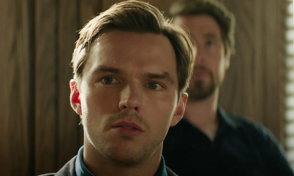 Nicholas Hoult stares in close-up with simmering unease in a still from the movie Juror #2.