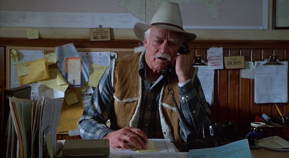 An old man talks on a phone in Misery.