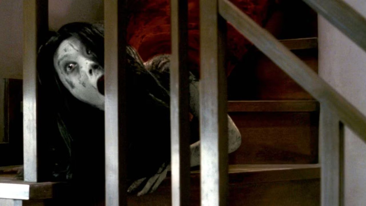 Takako Fuji as Kayako Saeki descending from a staircase in all fours in The Grudge.