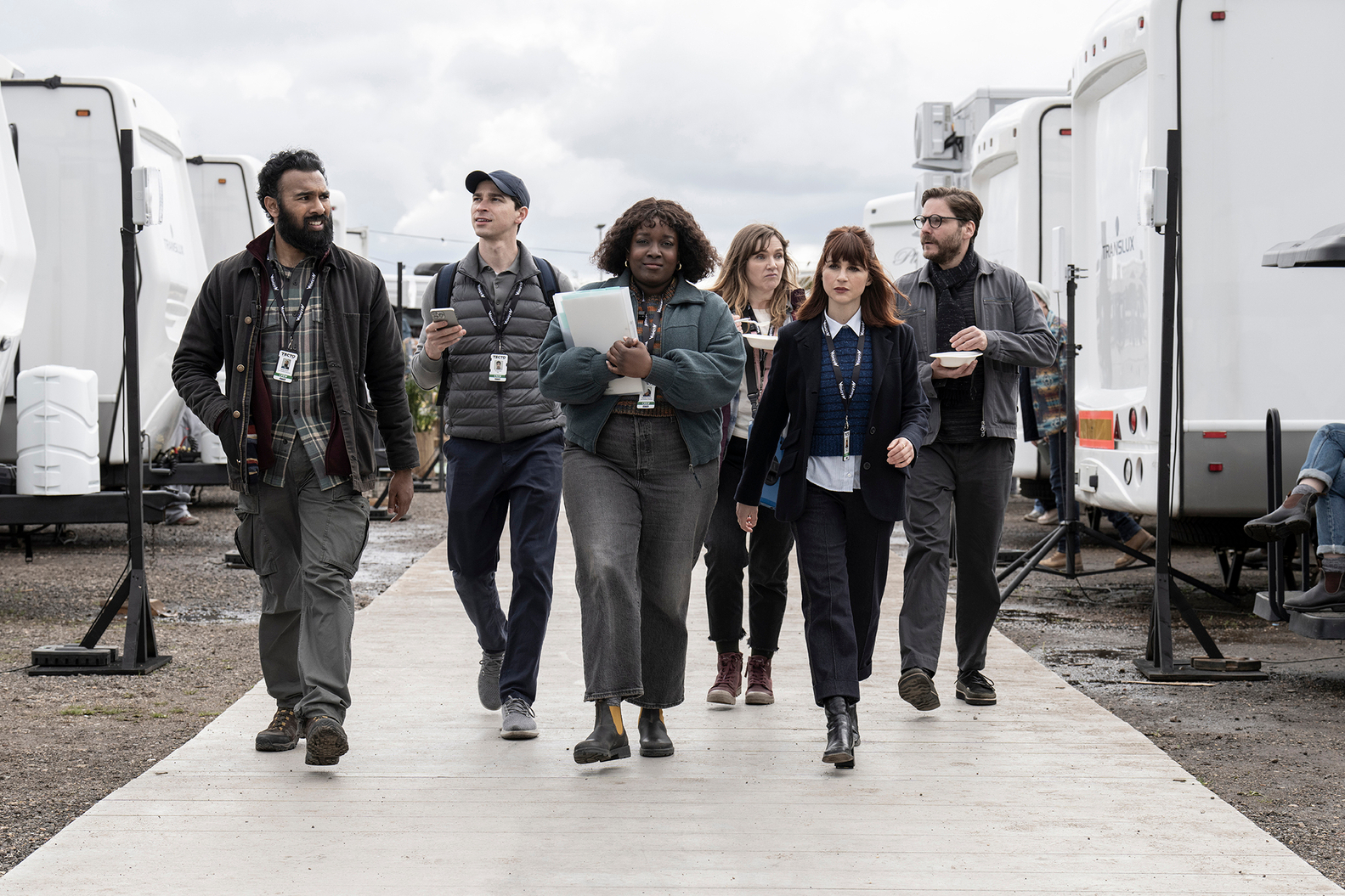 The Tecto crew walks between trailers together in The Franchise.