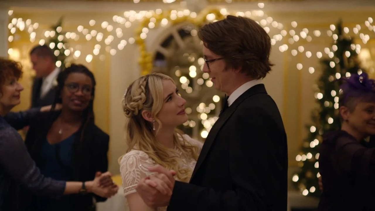 A young woman and man dressed up for a formal event slow dancing and looking at one another in About Fate.