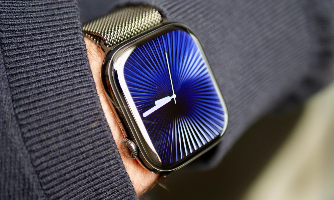 A person wearing the Apple Watch Series 10 in titanium with the Reflections watch face.