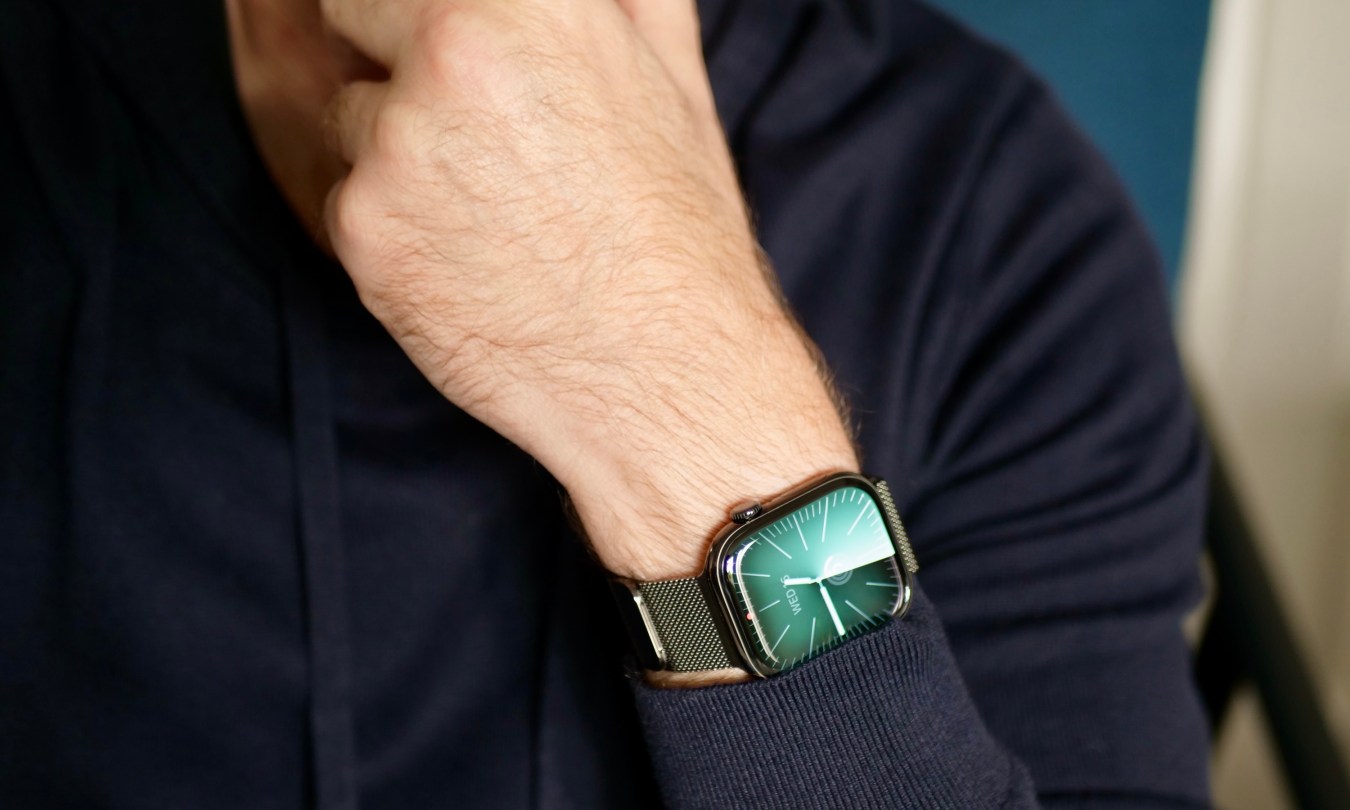 A person wearing the titanium Apple Watch Series 10.