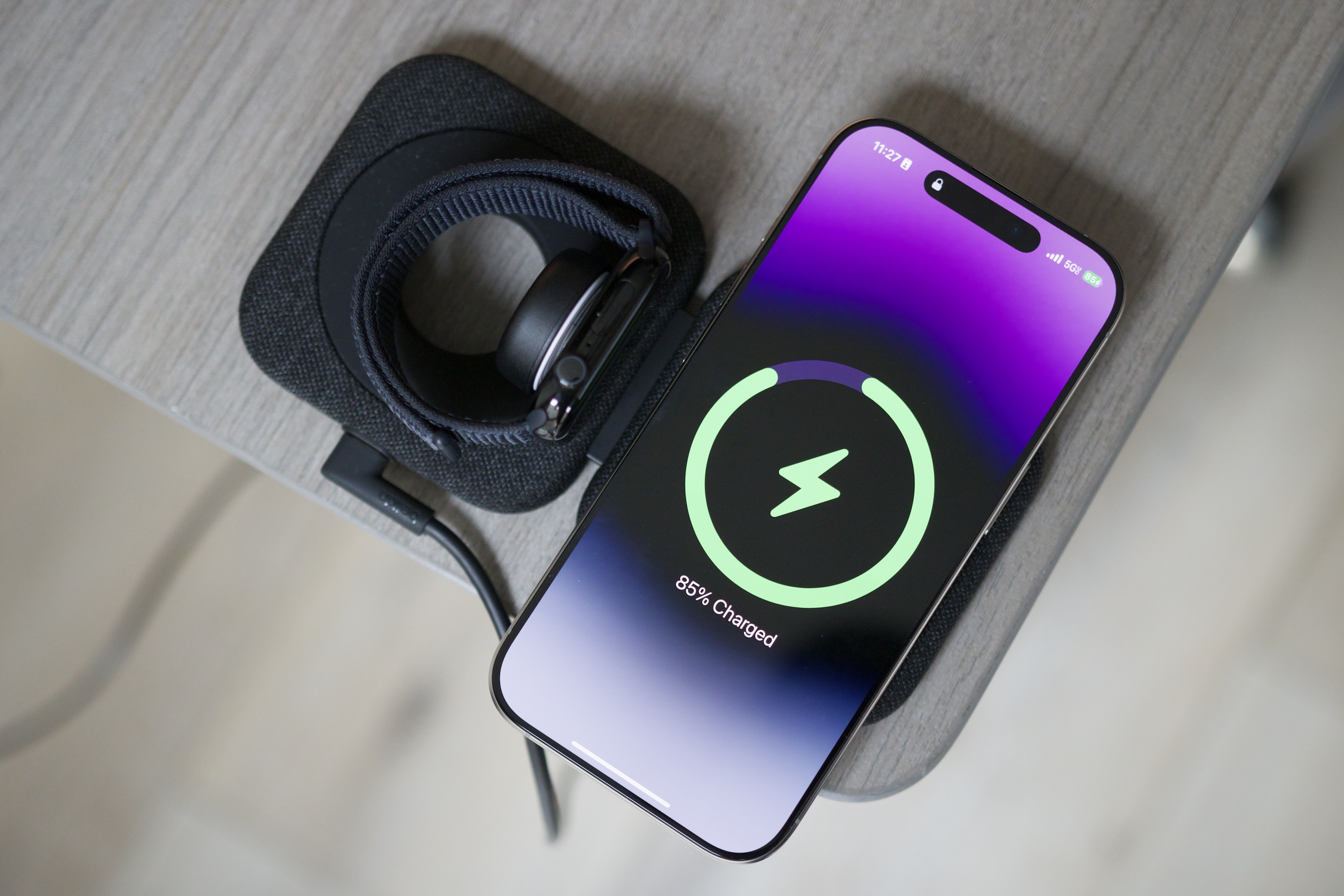 An iPhone and Apple Watch on the Belkin BoostCharge Pro Travel Pad.