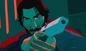 John Wick pointing a blocky looking gun at the screen. He's bathed in green.