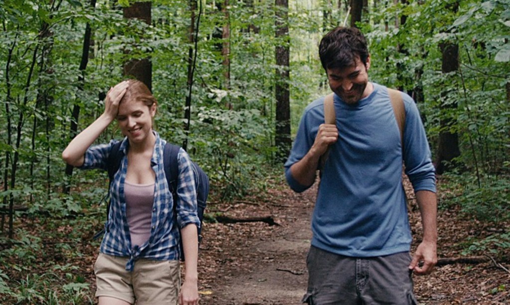 A man and a woman walk in the woods in Drinking Buddies.