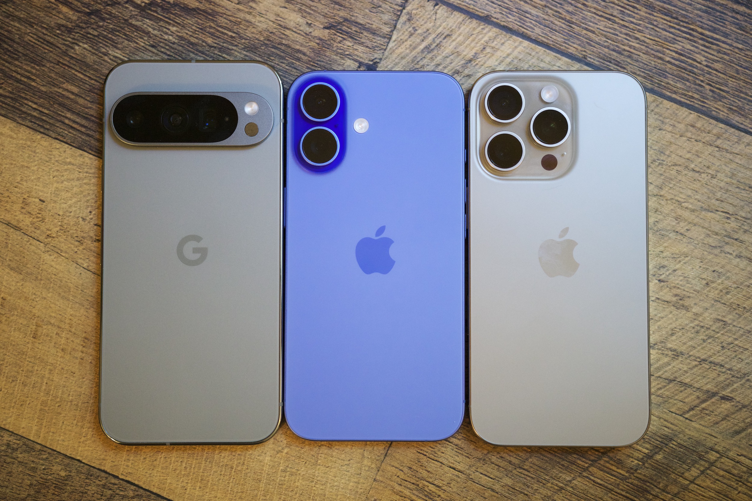 The iPhone 16 next to the Google Pixel 9 Pro and iPhone 16 Pro.