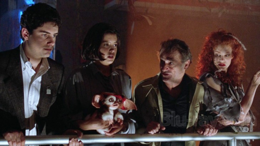 Four people and Gizmo look ahead in Gremlins 2: The New Batch.