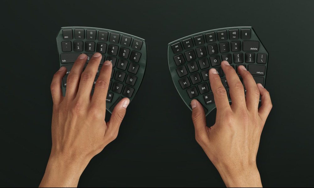 Two hands using the Nuio Flow ergonomic keyboard in green color.