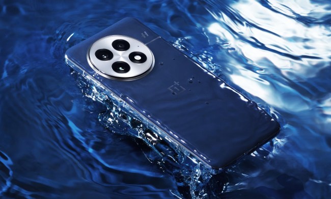 The blue OnePlus 13 in a pool of water.