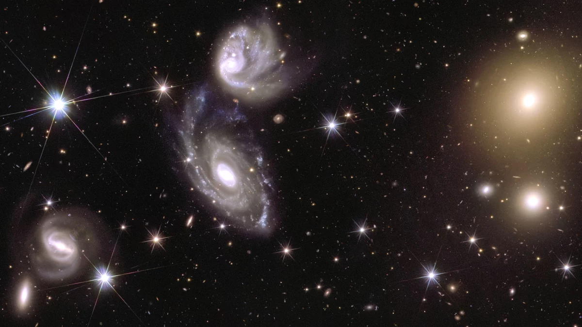 This image shows an area of ​​the mosaic released by ESA's Euclid Space Telescope on October 15, 2024. The area is zoomed in 150 times compared to the large mosaic. On the left of the image, Euclid captured two galaxies (named ESO 364-G035 and G036) interacting with each other, 420 million light years away from us. To the right of the image is the galaxy cluster Abell 3381, 678 million light years from us.