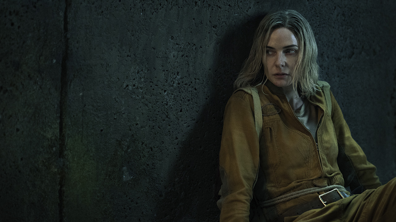 Juliette sits in the corner of a dark room looking ready to pounce in Silo on Apple TV+.