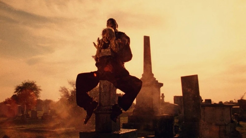 A skeleton rests on a gravestone in The Texas Chain Saw Massacre.