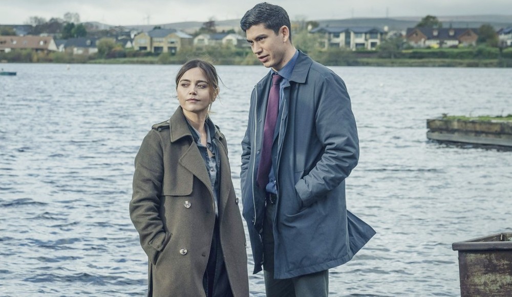 A man and a woman stand by a lake in The Jetty.