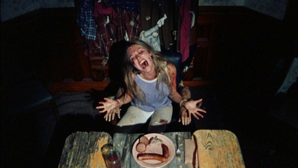 Sally screams at the dinner table in The Texas Chain Saw Massacre.