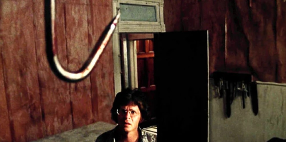 Jerry looks at a meat hook in The Texas Chain Saw Massacre.